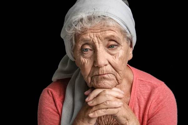 Depressive ältere Frau mit dunklem Hintergrund — Stockfoto