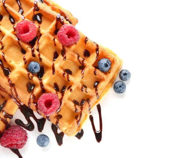 Delicious waffles with berries and chocolate sauce on white background — Stock Photo, Image
