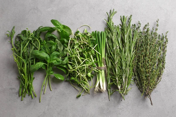 Fresh herbs on grey background, top view