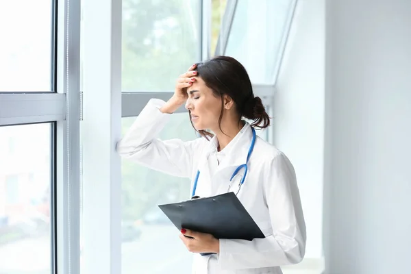 Müde Ärztin am Fenster ihres Büros — Stockfoto