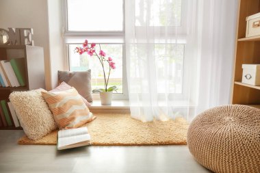 Diğer yumuşak yastık ve kitap pencere yakınındaki birlikte için rahat yerine