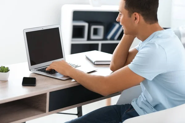 Young man working with laptop at home — Stock Photo, Image