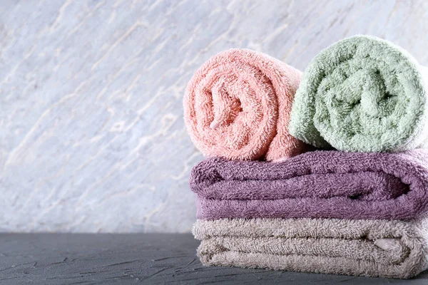 Clean soft towels on grey table — Stock Photo, Image