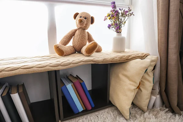 Cozy place for rest with book shelf near window in room — Stock Photo, Image