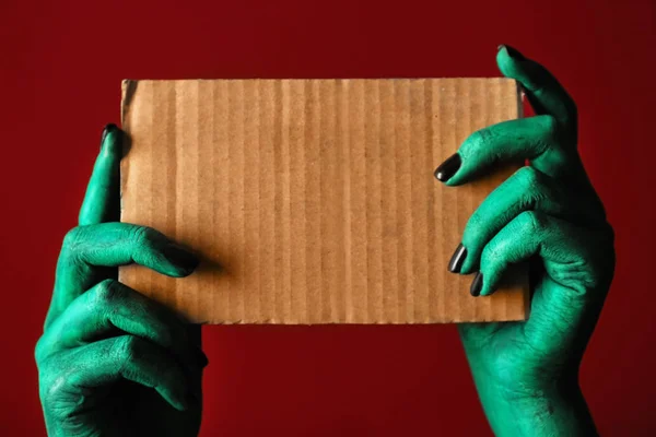 Monster holding blank card on color background — Stock Photo, Image