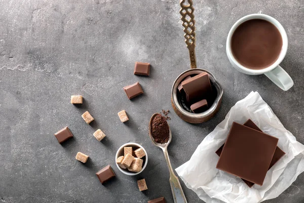 Cup of hot chocolate with ingredients on grey table — Stock Photo, Image