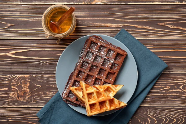 Plate with delicious waffles and honey on wooden table — Stock Photo, Image