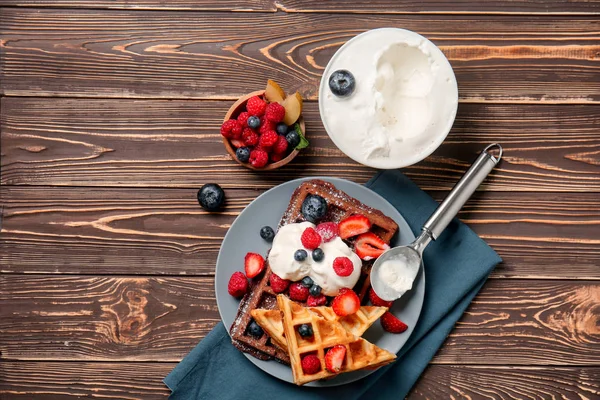 Delicious waffles with berries and ice cream on wooden table — Stock Photo, Image