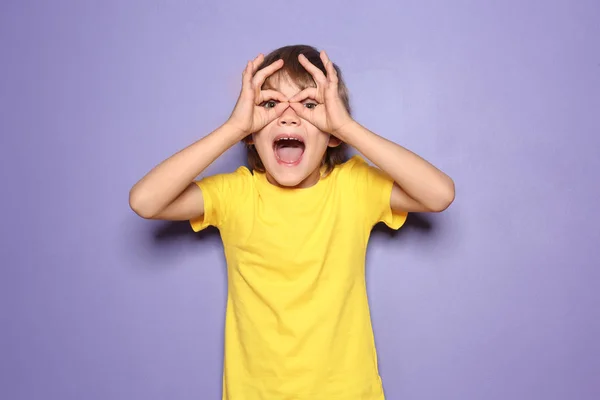 Funny little boy in t-shirt on color background — Stock Photo, Image