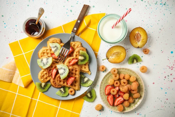 Heart shaped waffles with fruits, berries and glass of milk on light table — Stock Photo, Image
