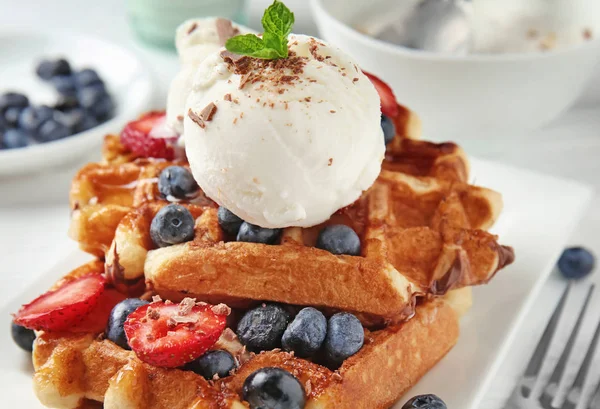 Delicious waffles with berries and ice cream on plate, closeup — Stock Photo, Image