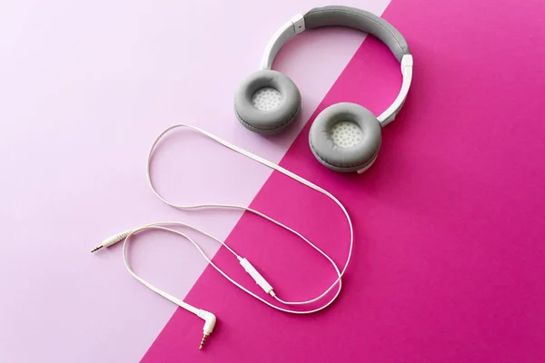 Modern headphones and earphones on color background — Stock Photo, Image