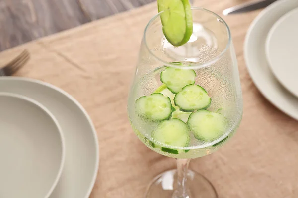 Glass of fresh cucumber water on dining table