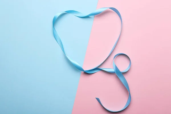 Curled blue ribbon on color background — Stock Photo, Image