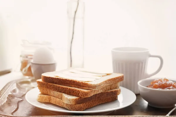 Tasty toasts, boiled egg, cup of coffee and jam on metal tray — Stock Photo, Image
