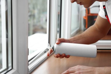 Genç bir işçi pencere dairede yükleme