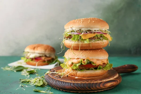 Stack of tasty burgers on table — Stock Photo, Image