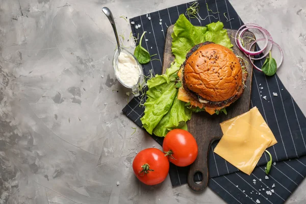 Composition with tasty burger on table — Stock Photo, Image