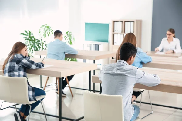 Pupils passing school test in classroom — Stock Photo, Image