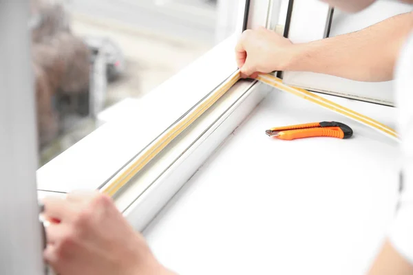 Young worker installing window in flat — Stock Photo, Image