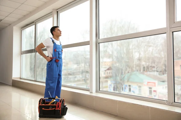 Young worker in room with big windows — Stock Photo, Image