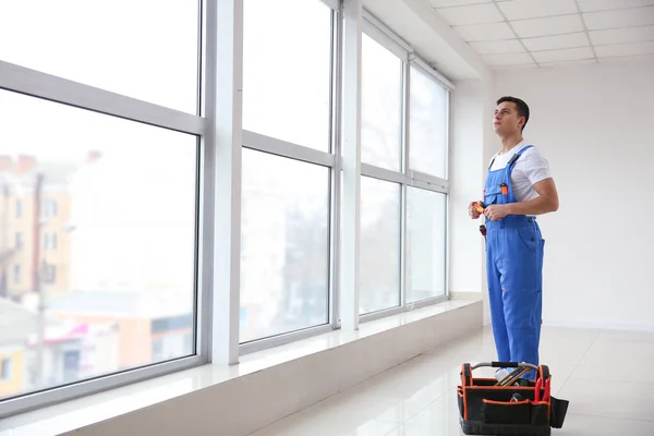 Young worker in room with big windows — Stock Photo, Image