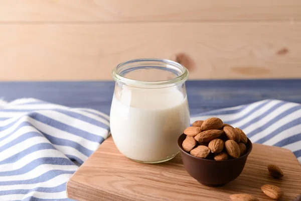 Glass jar of healthy almond milk on table — Stock Photo, Image