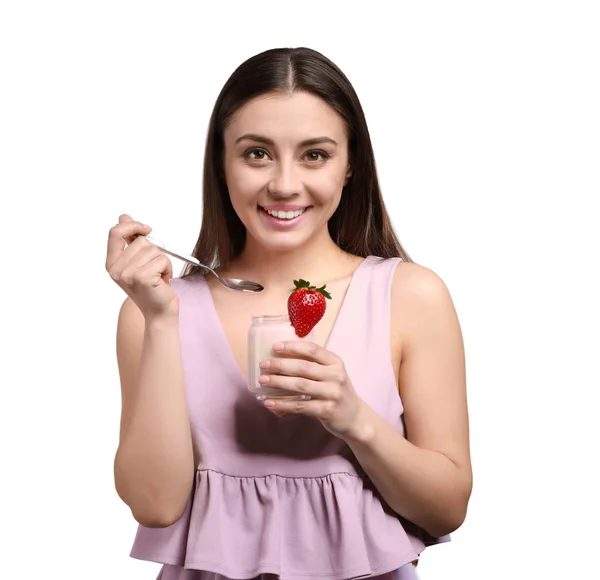 Young woman eating tasty yogurt on white background — Stock Photo, Image