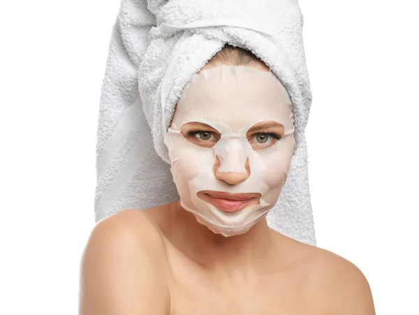 Beautiful young woman with sheet facial mask on white background — Stock Photo, Image