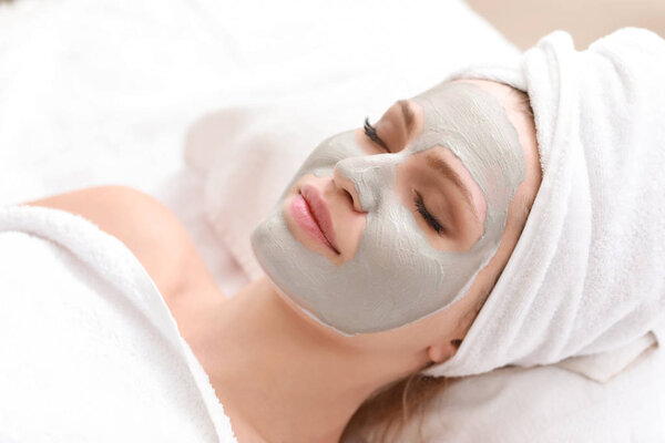 Young woman with facial mask in beauty salon
