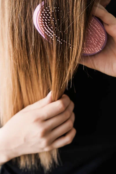Νεαρή γυναίκα βούρτσισμα μακριά μαλλιά — Φωτογραφία Αρχείου
