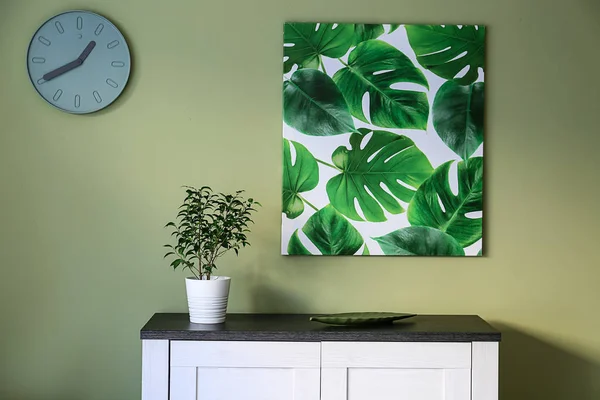 Cabinet and picture with tropical leaves in room — Stock Photo, Image