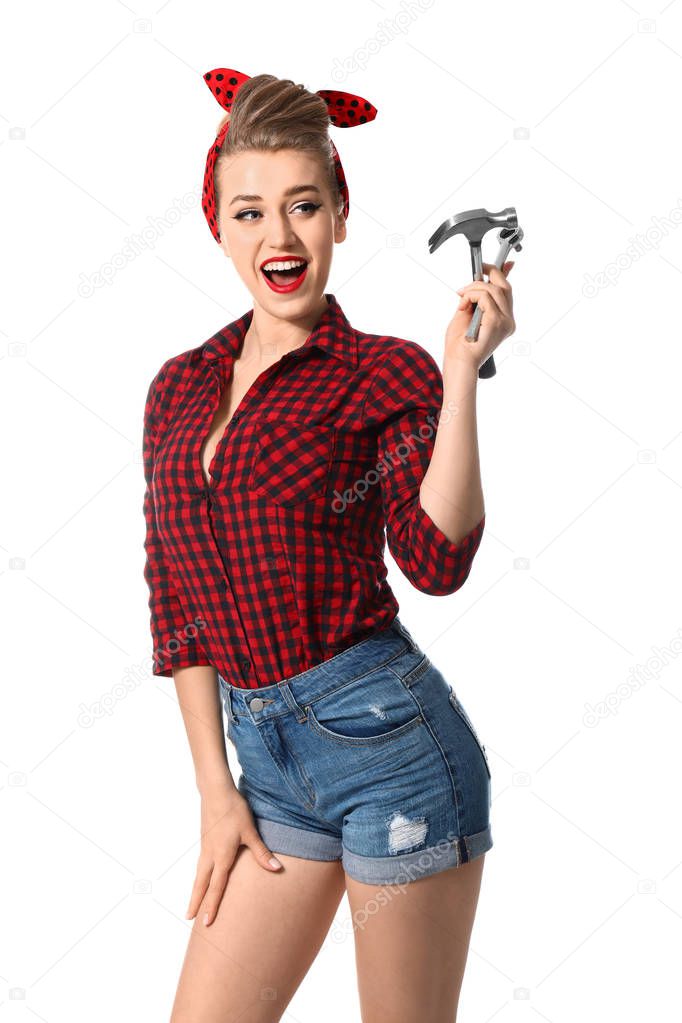 Beautiful pin-up woman with tools on white background