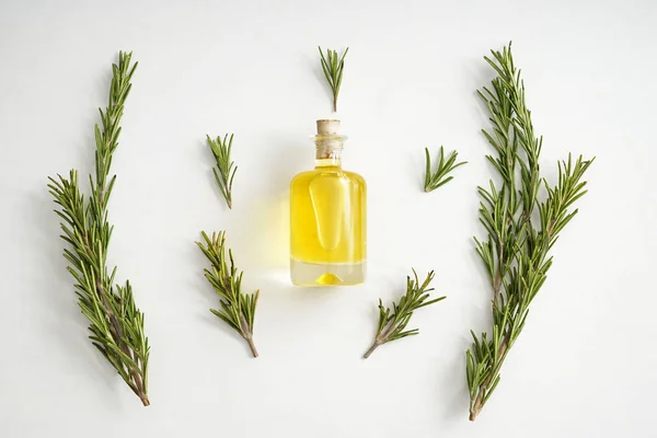 Bottle of rosemary oil on white background — Stock Photo, Image