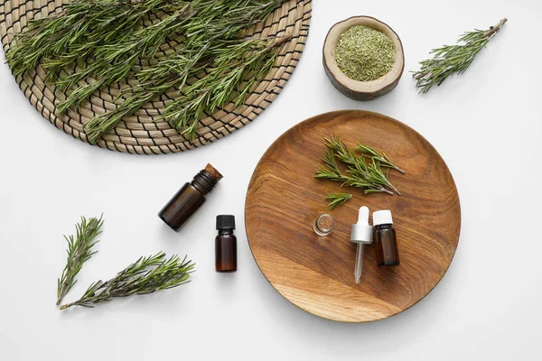 Bottles of rosemary oil on white background — Stock Photo, Image