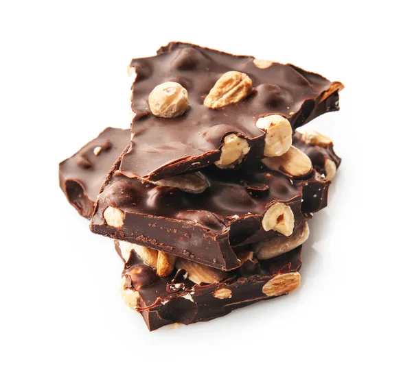 Chocolate escuro saboroso com nozes no fundo branco — Fotografia de Stock