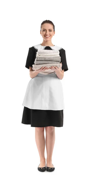 Portrait of beautiful female housekeeper with clean towels on white background — Stock Photo, Image