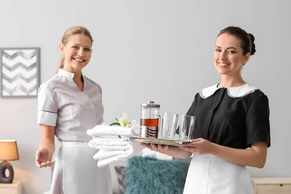 Portrait of beautiful female housekeepers in room — Stock Photo, Image