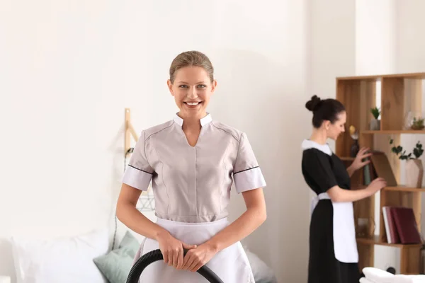 Portrait of beautiful female housekeeper in room — Stock Photo, Image