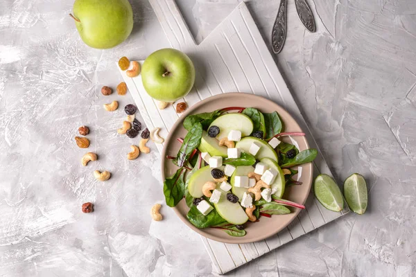 Healthy salad with feta cheese on grey table — Stock Photo, Image