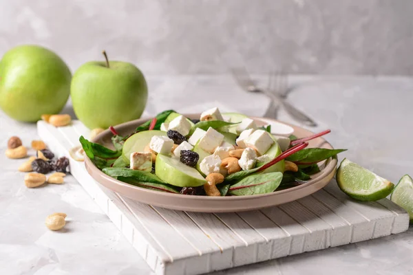 Healthy salad with feta cheese on grey table — Stock Photo, Image