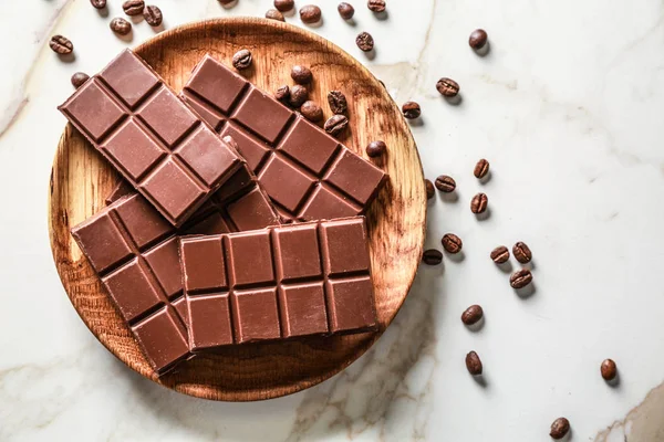 Plate with sweet tasty chocolate on table — Stock Photo, Image