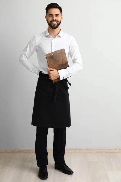 Handsome waiter near light wall — Stock Photo, Image