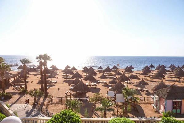 View of beach with comfortable sun loungers at resort — Stock Photo, Image