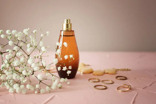 Fles parfum met bloemen en accessoires op kleurentabel — Stockfoto