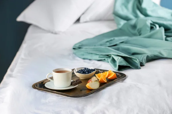Metal tray with delicious breakfast on bed — Stock Photo, Image