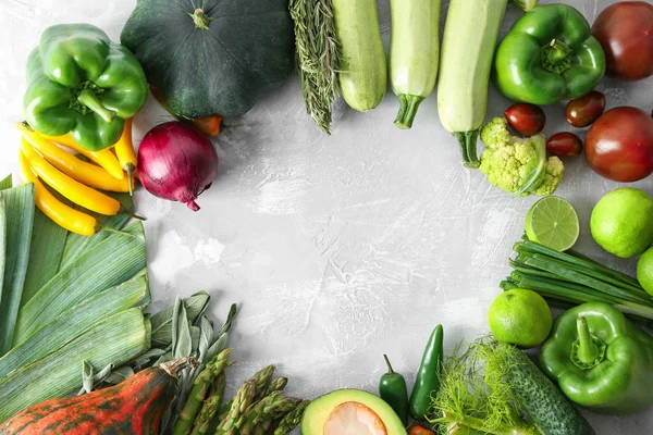 Frame made of various fresh vegetables on grey background — Stock Photo, Image