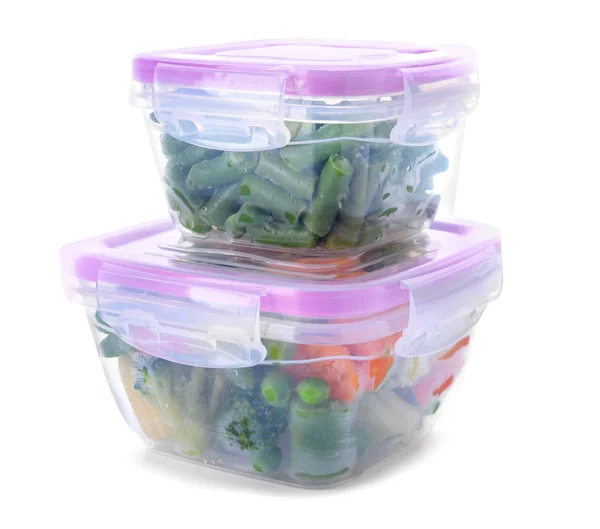 Plastic containers with frozen vegetables on white background — Stock Photo, Image