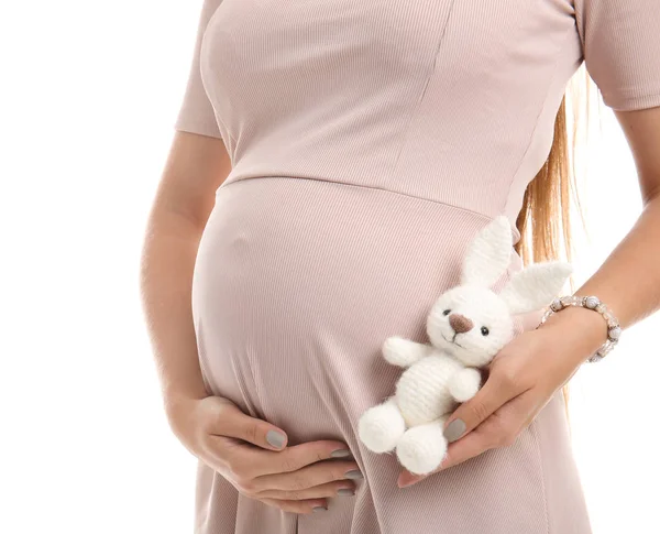 Krásná těhotná žena s hračkou na bílém pozadí — Stock fotografie