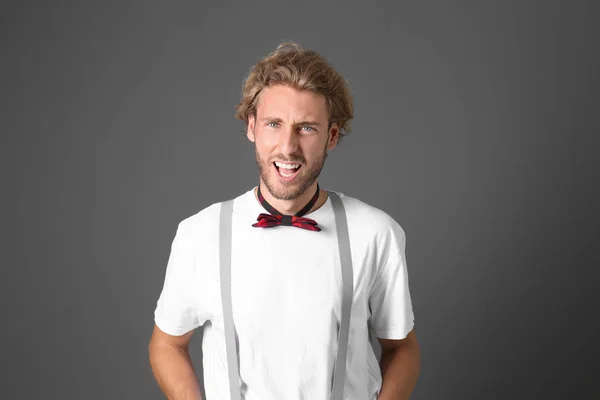 Portrait of handsome emotional man on grey background — Stock Photo, Image